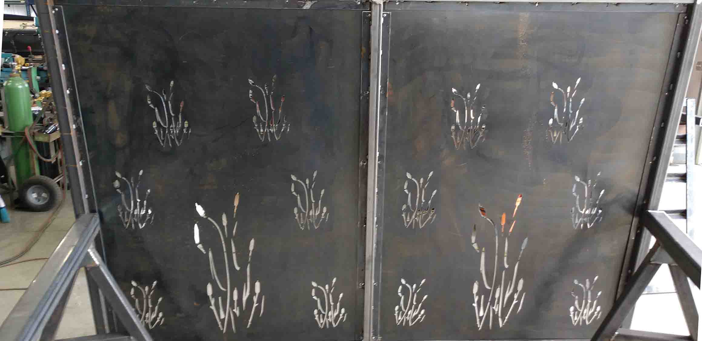 Picture of a fence privacy screen with intricate cutouts.