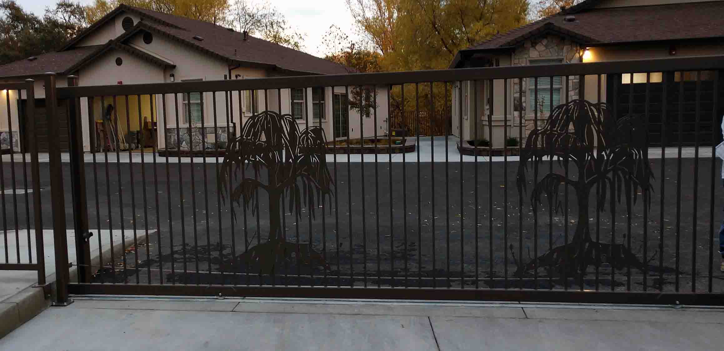 Picture of gate with palm tree decoration.