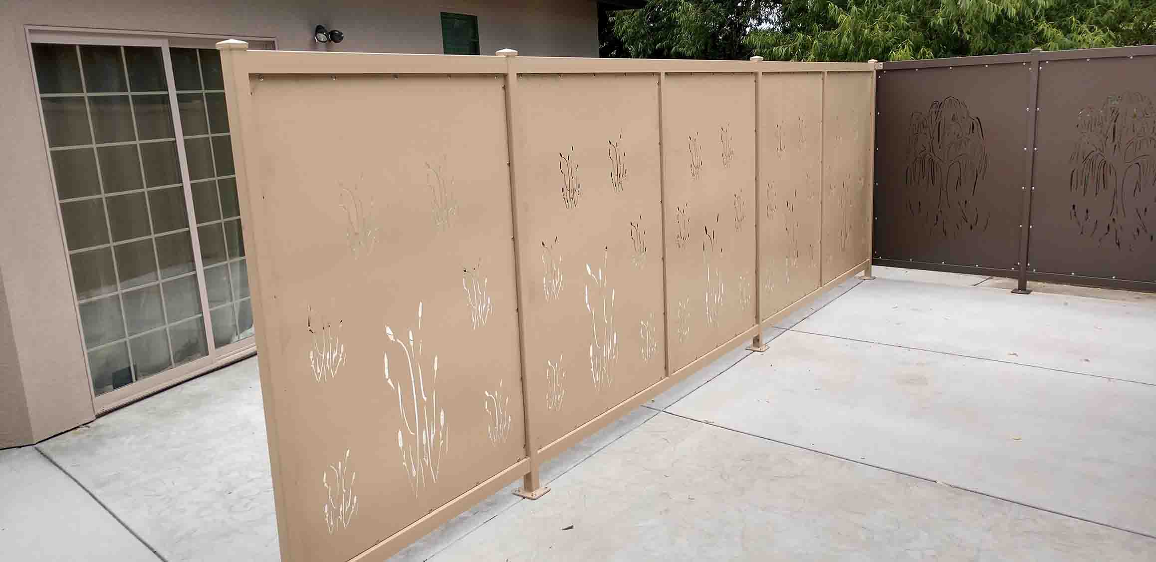 Picture of a fence privacy screen with intricate cutouts.