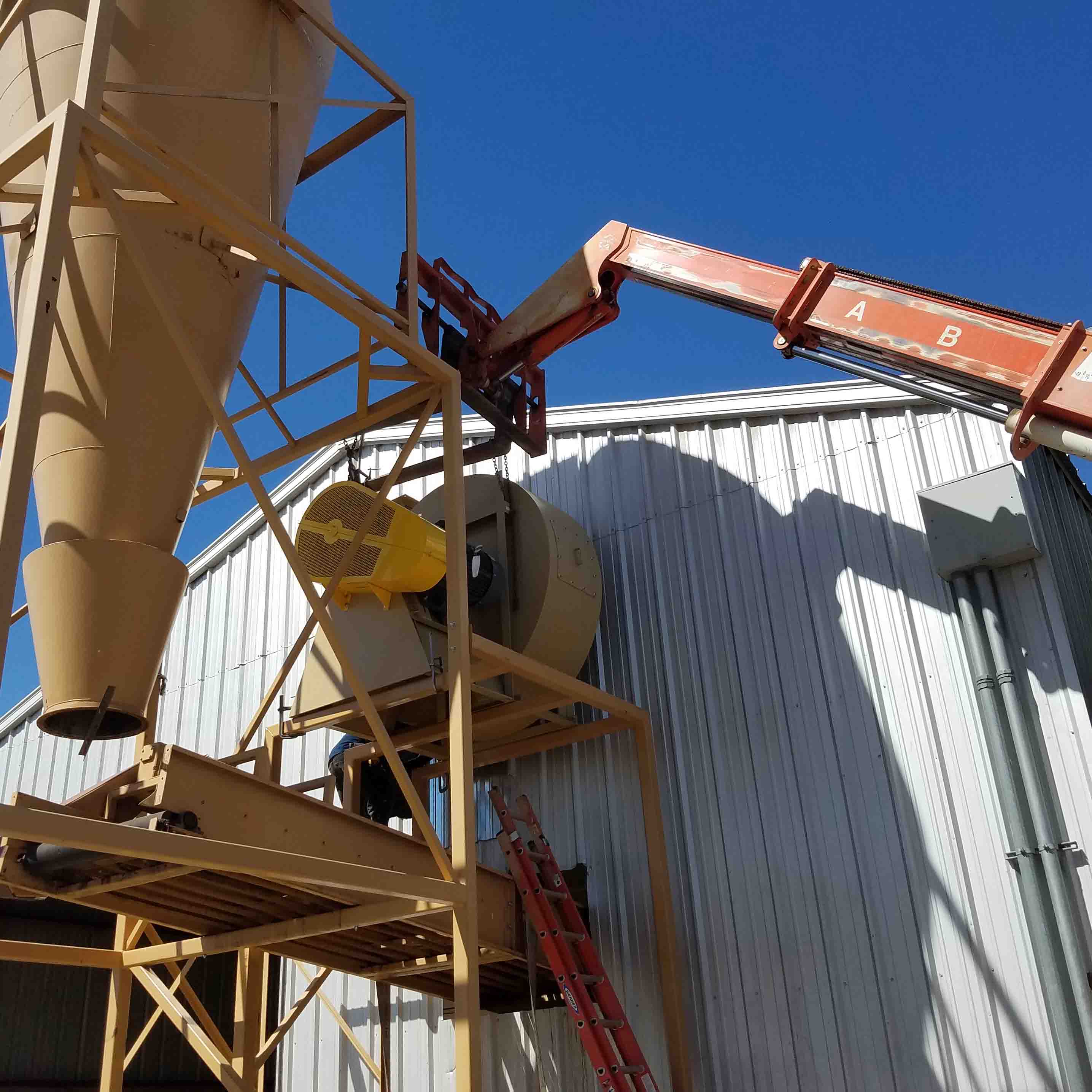 Picture of agricultural equipment being installed.